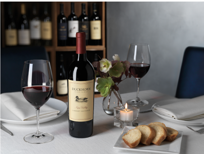 Duckhorn Cabernet Sauvignon bottle and glasses of red wine on a restaurant table
