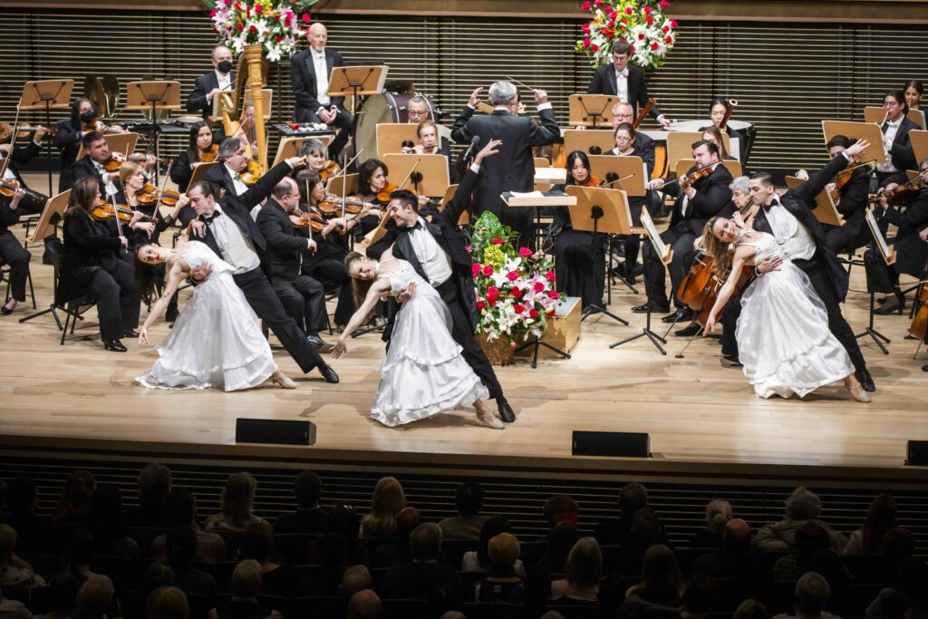 Orchestra and ballroom dancers performing onstage during Salute to Vienna New Year's Concert